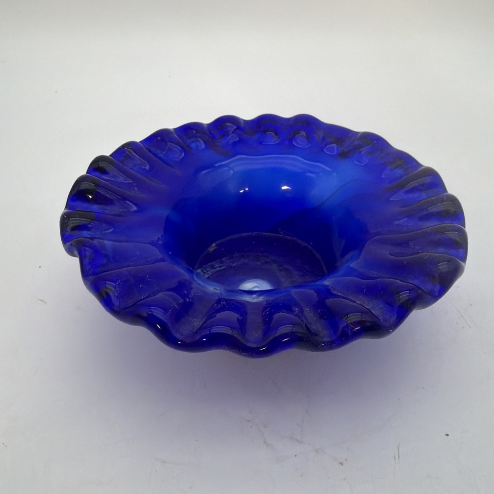 vibrant cobalt blue art glass bowl features a striking ruffled rim